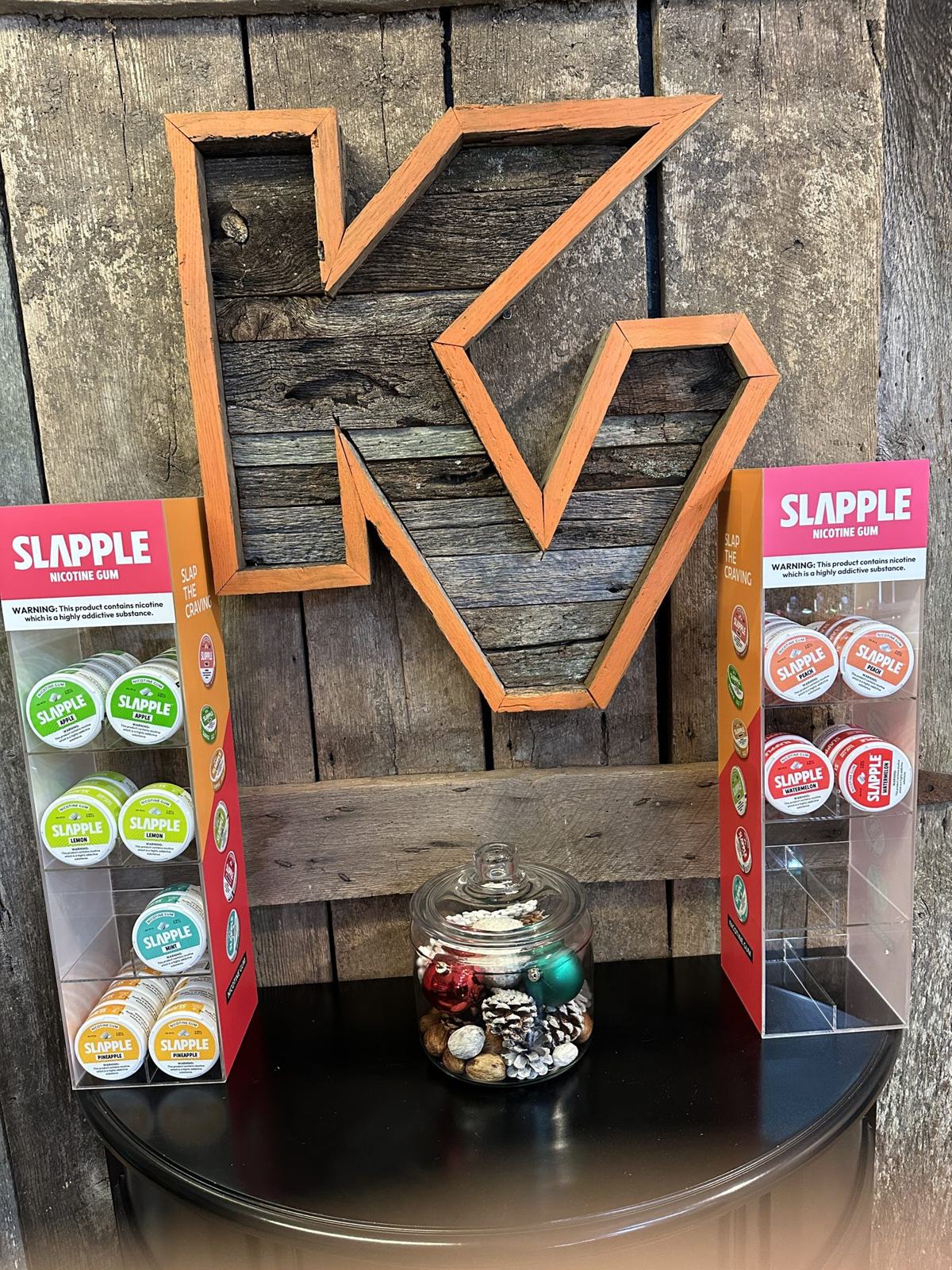 Nicotine gum display under the barnwood KV letters