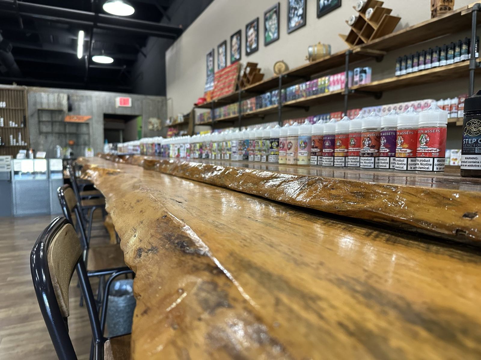 The live-edge wood bar inside a Knoxville Vapor shop