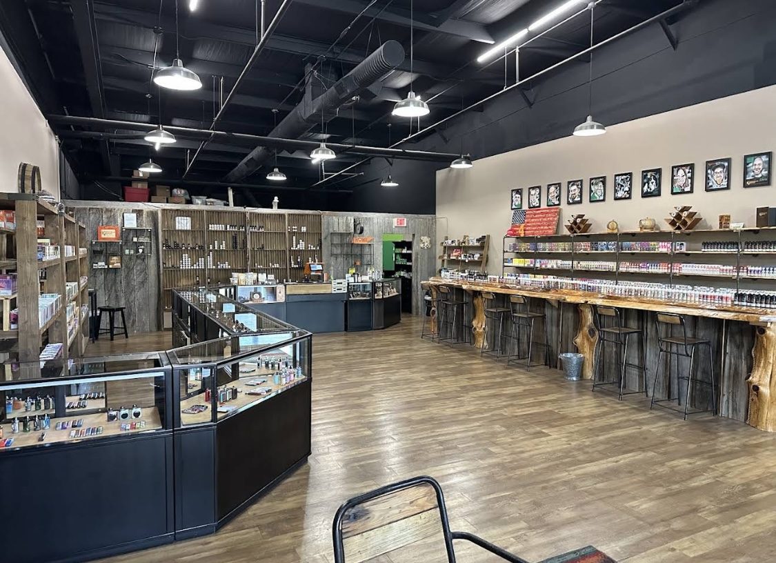 Inside the Pigeon Forge shop, with glass hardware counters and a long live-edge bar