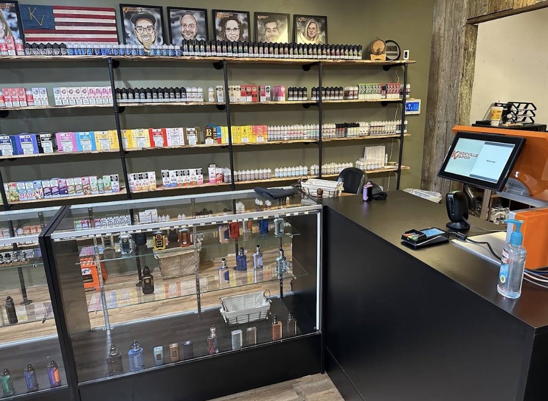 The Seymour counter, with hardware cases and an e-liquid wall under the crew caricatures