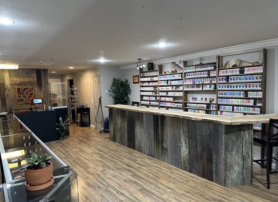 Inside the Seymour shop, with a barnwood bar and shelves of e-liquid and disposables