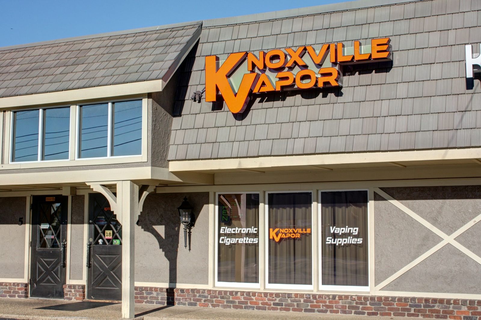 The Knoxville Vapor storefront and orange sign on Kingston Pike in Bearden Hill