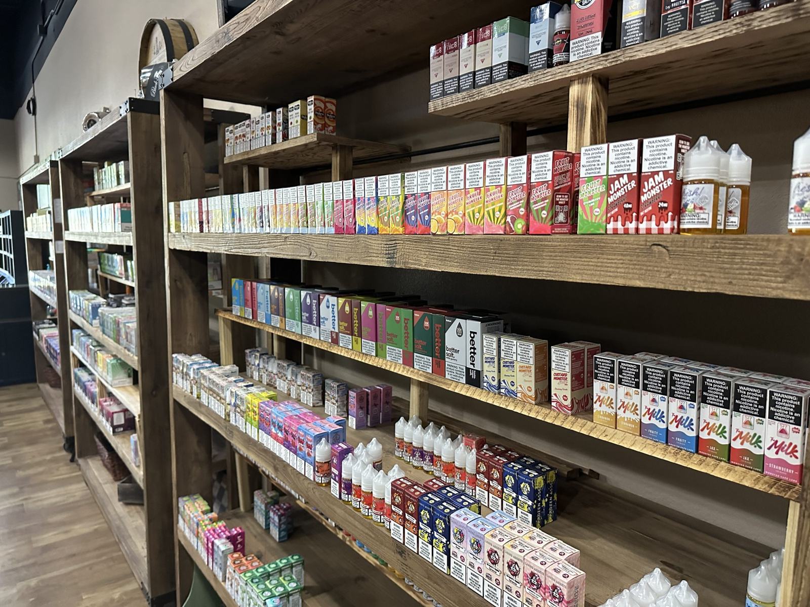 Wood shelves stocked with e-liquid